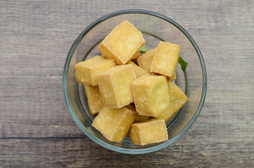fried tofu bowl isolated on wooden background