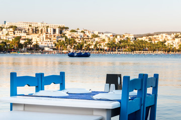 Tables in Bodrum town near beautiful Aegean Sea. Beach cafe near  sea, Turkey.  Sunset.