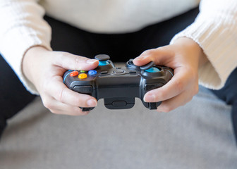 A person holding game controller playing video games