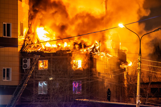 firefighters extinguish burning house in the dark, Burning building in Samara, Russia