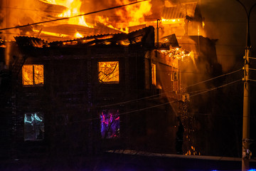 firefighters extinguish burning house in the dark, Burning building in Samara, Russia