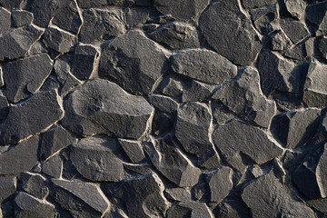 Natural grey stone masonry wall background