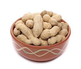 Shelled peanuts salted in clay pot isolated on white background