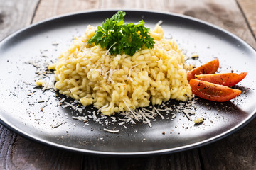 Risotto with parmesan on wooden background