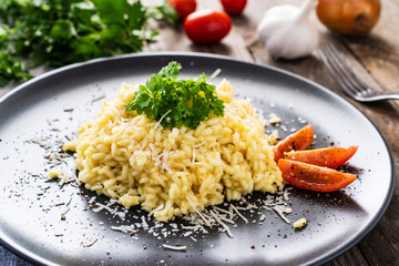 Risotto with parmesan on wooden background