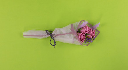 bouquet of pink roses on a green background