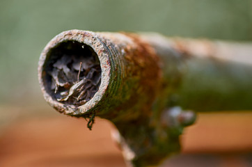 Rusty pipe with garbage