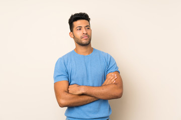 Young handsome man over isolated background with confuse face expression