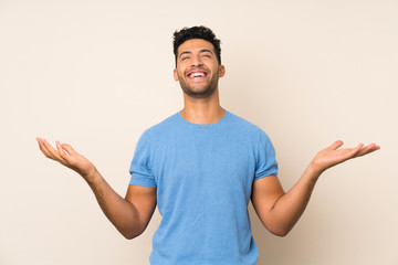 Young handsome man over isolated background smiling a lot