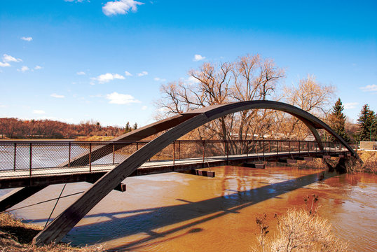 Footbridge across Wascana creek in Regina, Saskatchewan. Spring time flood.