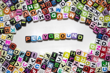 The word PLAYGROUND written with colorful cubes isolated on a white background