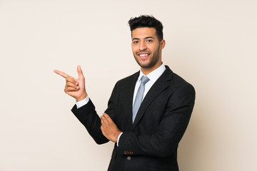 Young handsome businessman man over isolated background pointing finger to the side