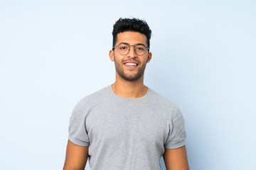 Young handsome man over isolated background with glasses