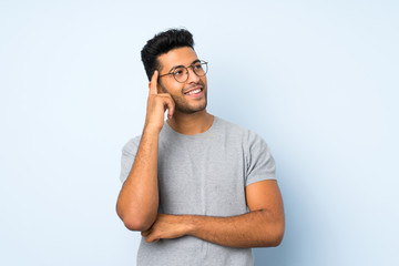 Young handsome man over isolated background with glasses