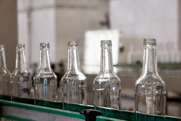 Bottles are moving on a conveyor belt at a factory for the production of Russian vodka