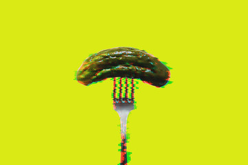Pickled cucumber on a fork in a glitch effect
