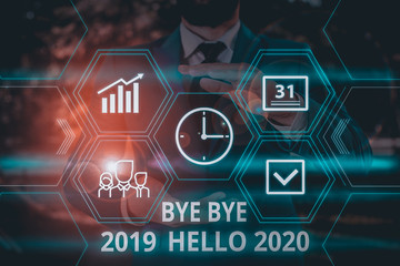 Word writing text Bye Bye 2019 Hello 2020. Business photo showcasing Starting new year Motivational message 2019 is over Male human wear formal work suit presenting presentation using smart device © A