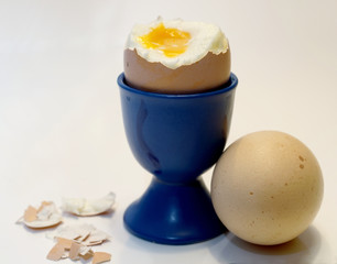 peeled soft-boiled egg in a cup