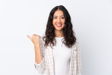 Mixed race woman over isolated white background pointing to the side to present a product