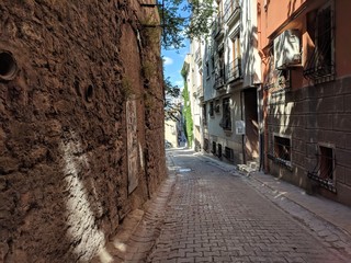 Istanbul, Turkey with cobblestone street and red-brown stone walls