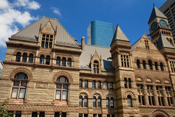 Fototapeta na wymiar Renovated stonework of the old 1889 Toronto City Hall with highrise buildings
