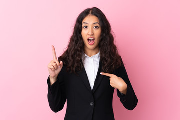 Mixed race business woman over isolated pink background with surprise facial expression