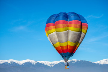 Fototapeta premium Hot air baloon in the mountain winter