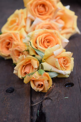 Yellow roses on wood background