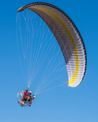 Paraglider motor in the blue sky