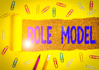 Conceptual hand writing showing Role Model. Concept meaning a demonstrating looked to by others as...