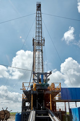 Fototapeta na wymiar Drilling rig against the blue sky