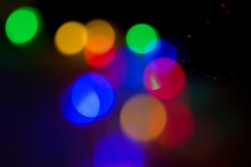 Colorful circular Christmas lights. Christmas tree bokeh.Bokeh effect. Green, blue, red and yellow lights christmas background.