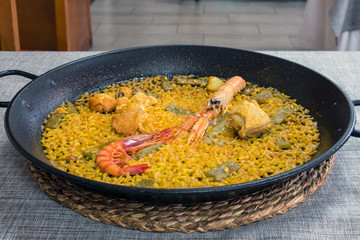 Traditional Valencian cuisine. The national Spanish dish of Valencia is Paella Valencia. Tasty lunch in a Spanish restaurant. Close-up.