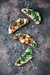 4 bruschetta with pumpkin, feta, olives, butter, avocado sun-dried tomatoes and arugula