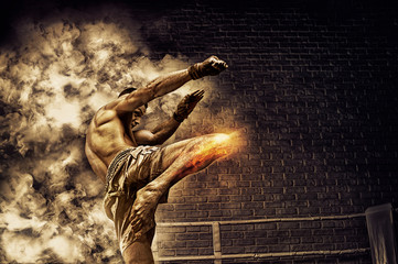 Thai boxer in the ring hits with a knee. The concept of sports, gyms, boxing clubs.