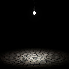 illuminated stone floor on a black background