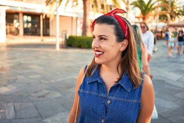 Fototapeta premium Young beautiful woman smiling happy walking on city streets of Puerto de la Cruz, Tenerife on a sunny day of summer