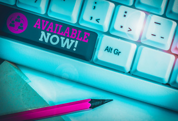 Conceptual hand writing showing Available Now. Concept meaning you can find it obtain or operable at this current moment White pc keyboard with note paper above the white background