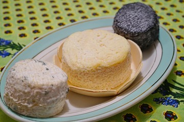 A platter with French goat cheese on a colorful tablecloth
