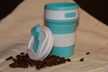 Blue reusable cup transformer for coffee and drinks take away made of food silicone. Repeated...