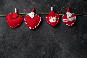 Valentine's day background. hearts on a rope with clothespins on a stone background with copy space for your text