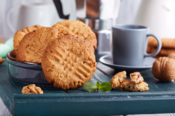 Delicious homemade crispy cookies with walnuts. Served with cup of coffee. 