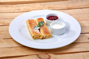 pancakes with sour cream and berry sauce