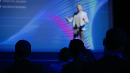 Tech Conference Auditorium Hall, Speaker Does Presentation New Product on Market, Talks about Performance Comparison. Focus on Applauding Audience. Device Release / Start-up Business Conference