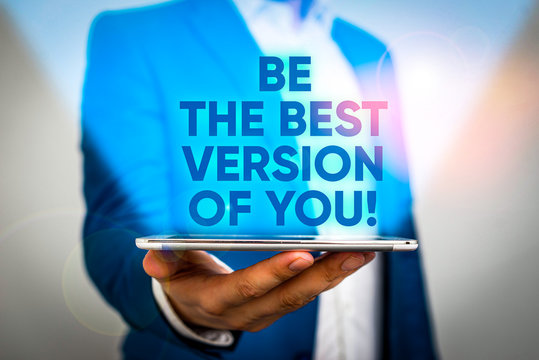 Writing note showing Be The Best Version Of You. Business concept for going to move away from where are start improving Man in the blue suite and white shirt holds mobile phone in the hand