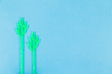 Madler in the form of a cactus for mixing drinks on a blue background