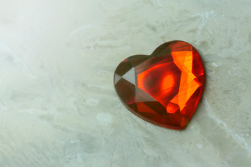 background of white marble. Red heart. Close-up. copy space.