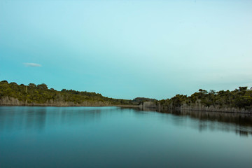 landscape with lake and clouds. Pond vegetation with clear skies and crystal clear water. Photo for background.