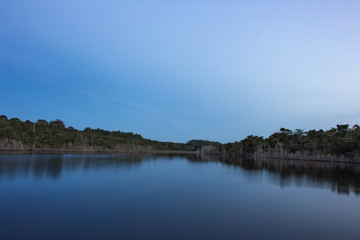clouds over lake. Pond vegetation with clear skies and crystal clear water. Photo for background.