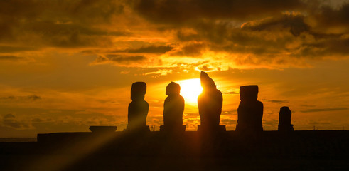 SUN FLARE: Golden sunset illuminates a row of moai statues on Easter Island.